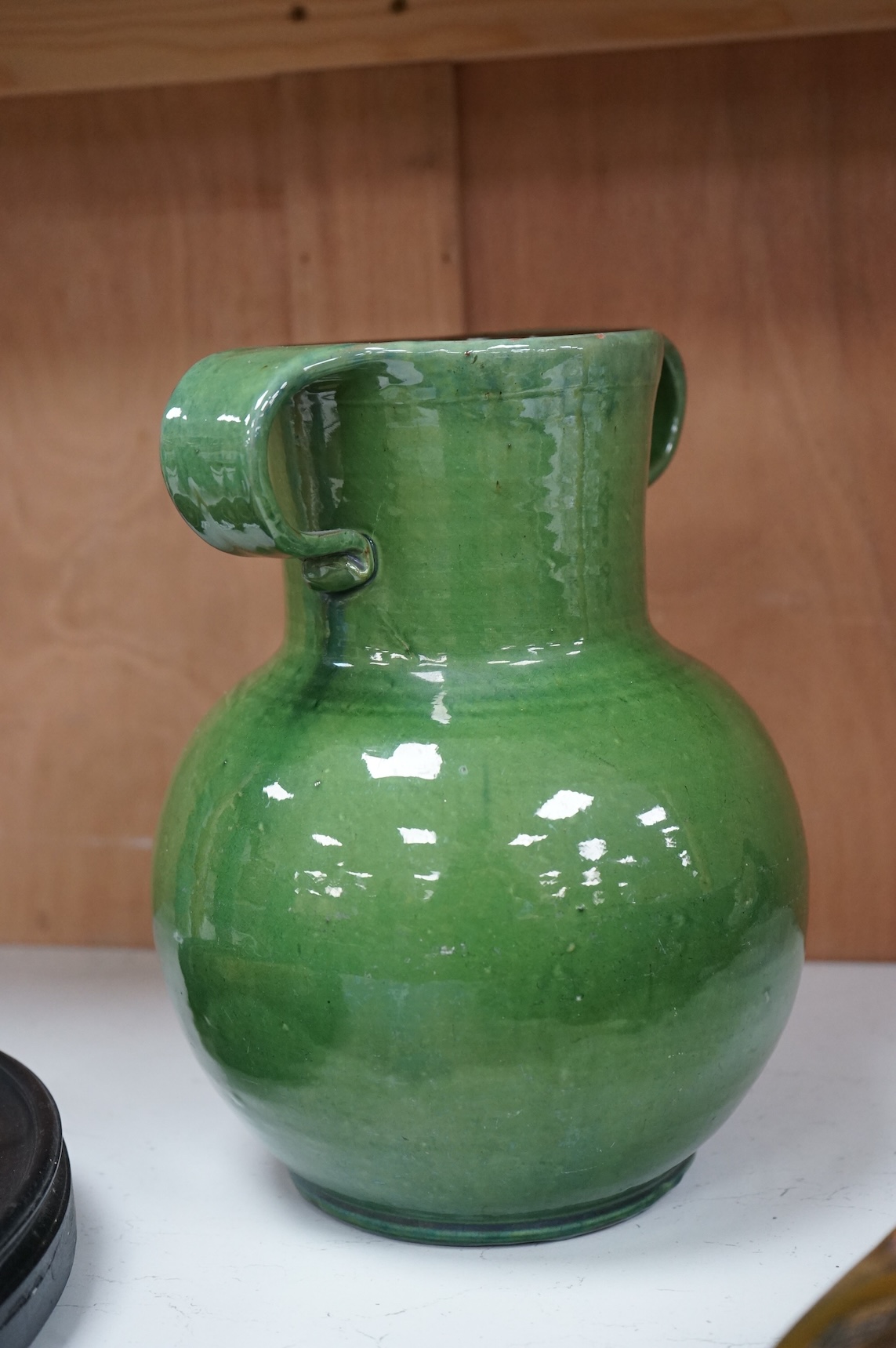 A Brannam green glazed twin handled vase, 29cm high